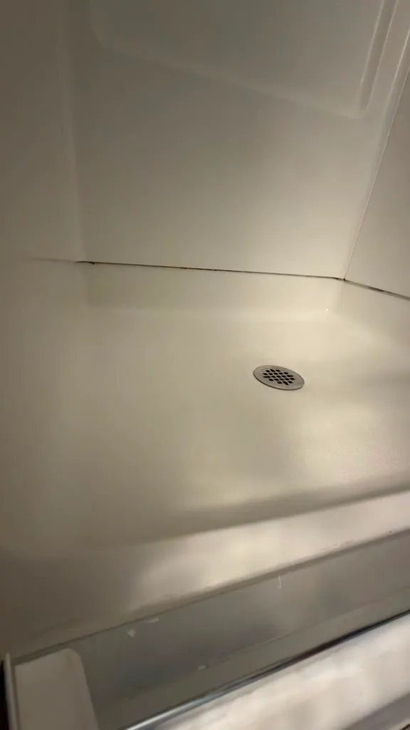 The same shower base clean into the corners after cleaning by Dolane Cleaning Services