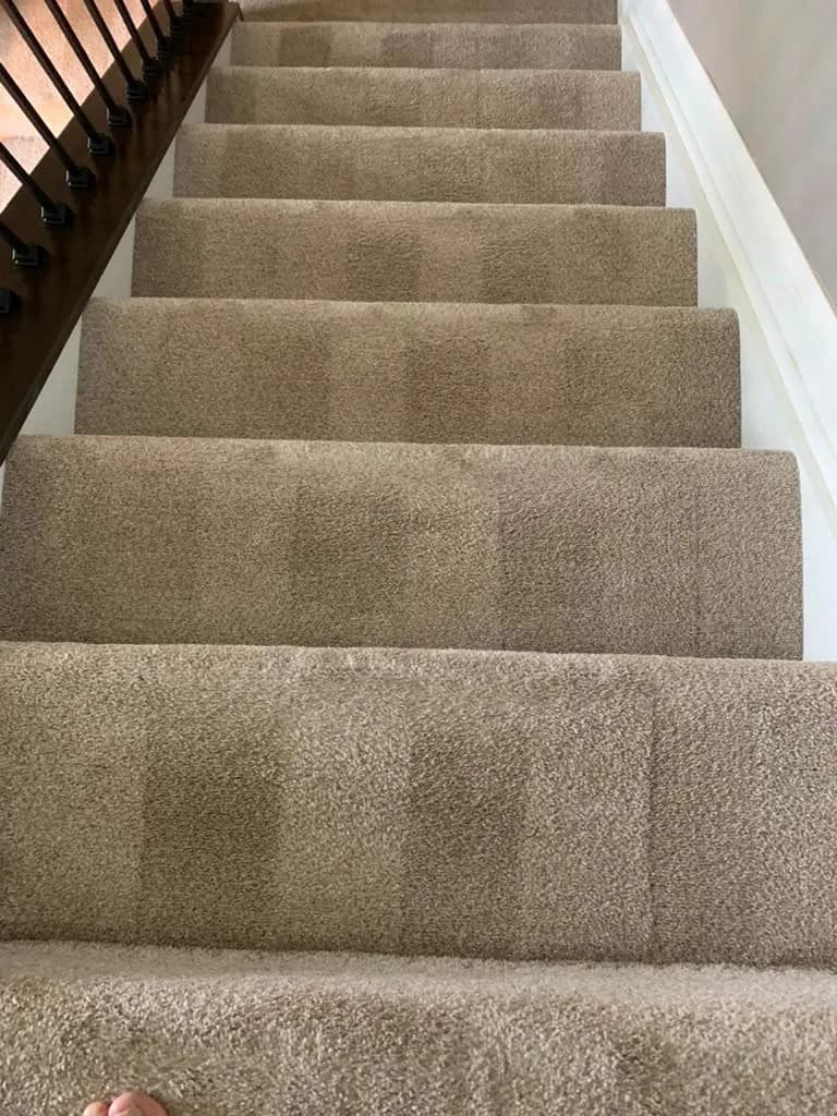 Carpeted staircase vacuumed step by step by Dolane Cleaning Services