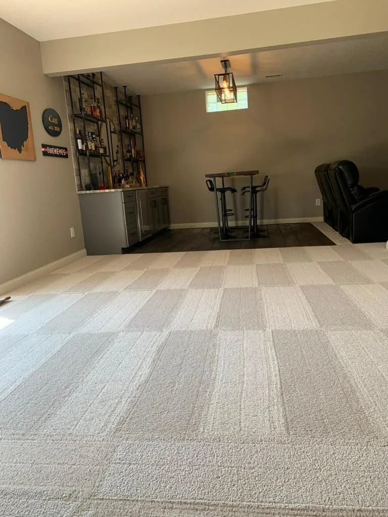 Lower-level living area with carpet vacuumed in clean lines by Dolane Cleaning Services